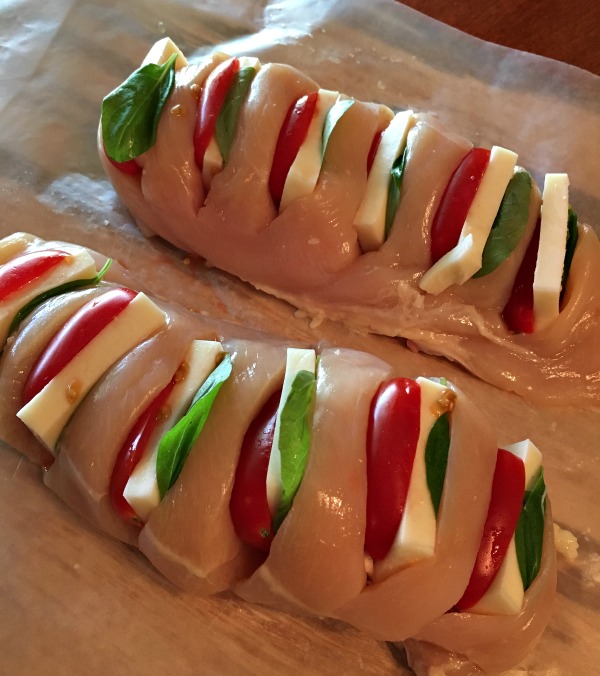 Chicken Stuffed with Mozzarella, Tomato and Basil on cutting board from Walking on Sunshine Recipes